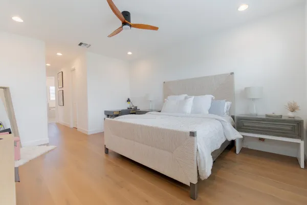 a bedroom with a bed and a large window