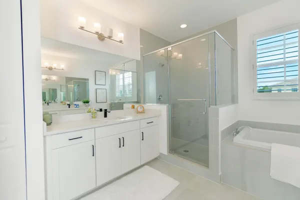 a bathroom with a double vanity sink toilet and shower