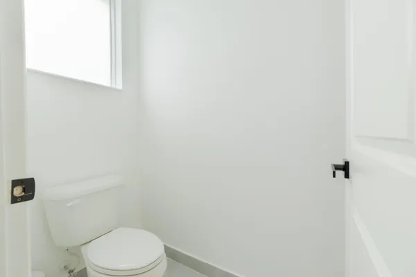 a white toilet sitting next to a white sink