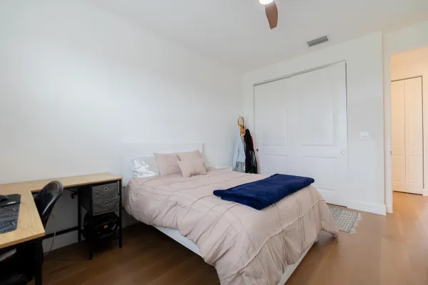 a bedroom with a bed and a dresser in it