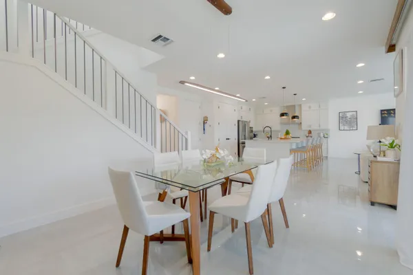 a dining room with furniture and entryway
