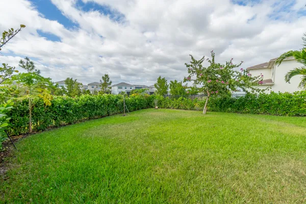 a view of a garden with a building in the background
