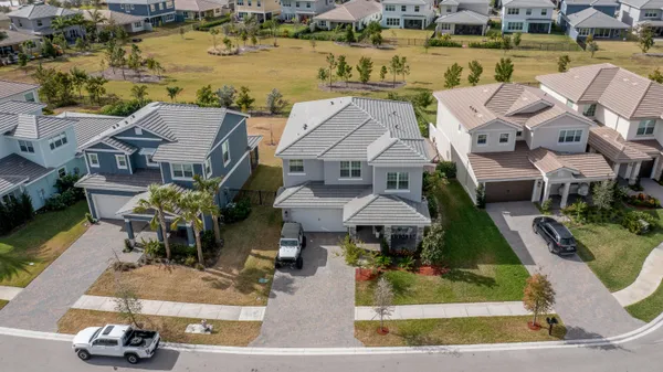 an aerial view of a house with garden space and lake view