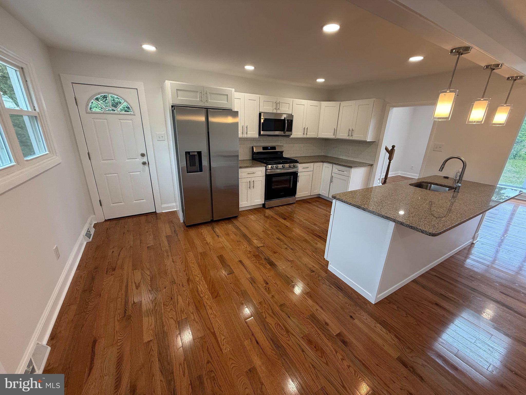 1104 Church Road Wyncote, PA 19095 - Photo 10 of 31 a kitchen with stainless steel appliances granite countertop a refrigerator a stove and a wooden floors