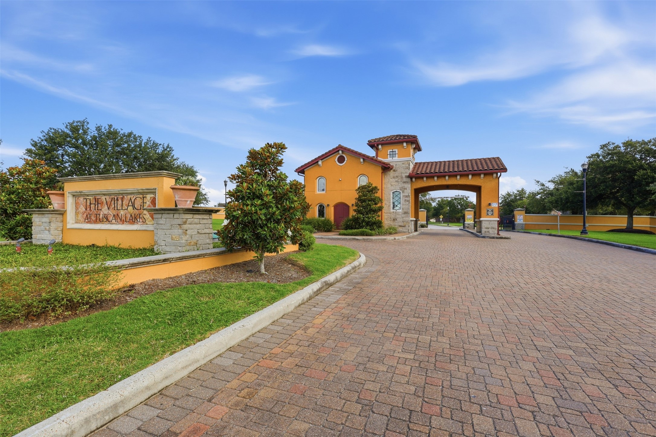721 Rufina Street League City, TX 77573 - Photo 23 of 33 Welcome home to The Village at Tuscan Lakes, a gated 55+ community with beautifully maintained grounds and a grand Mediterranean-inspired entrance.