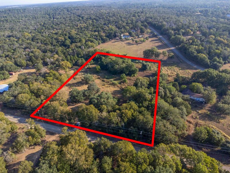 135 Ann Powell Road Smithville, TX 78957 - Photo 8 of 8 Aerial overview of property's location with property parcel outlined and a forest