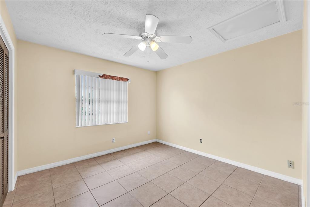 3420 Yale Circle Riverview, FL 33578 - Photo 14 of 30 an empty room with chandelier fan and windows