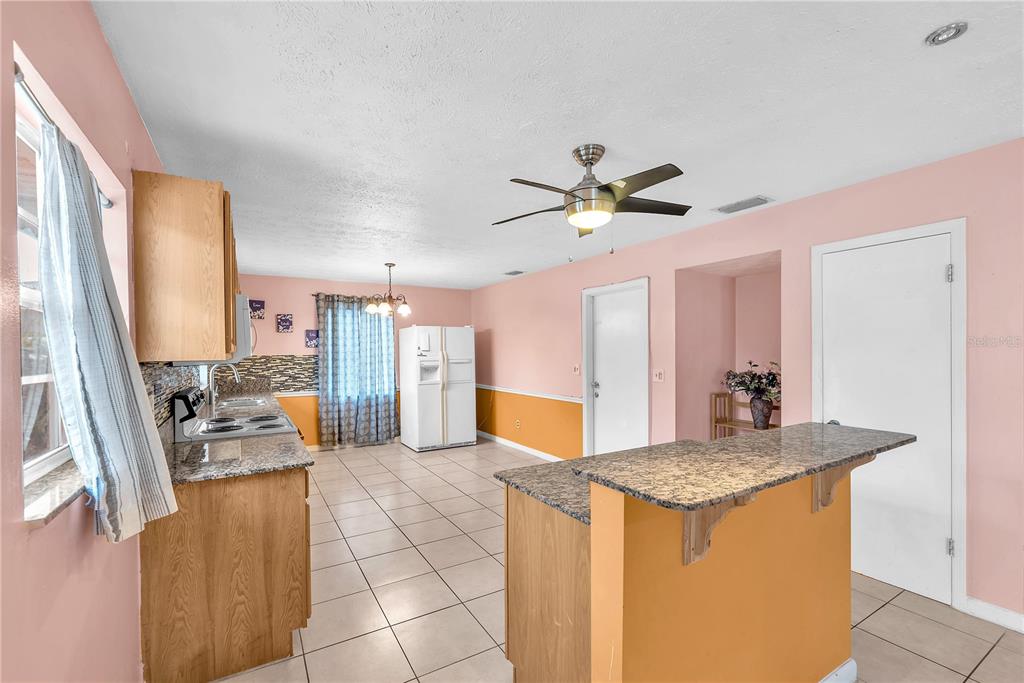 3420 Yale Circle Riverview, FL 33578 - Photo 6 of 30 a view of a kitchen with granite countertop a sink and a stove