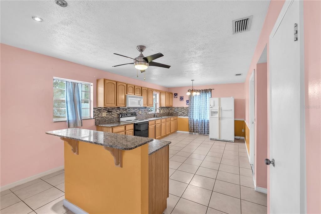 3420 Yale Circle Riverview, FL 33578 - Photo 7 of 30 a view of a kitchen with kitchen island stainless steel appliances counter space and a chandelier