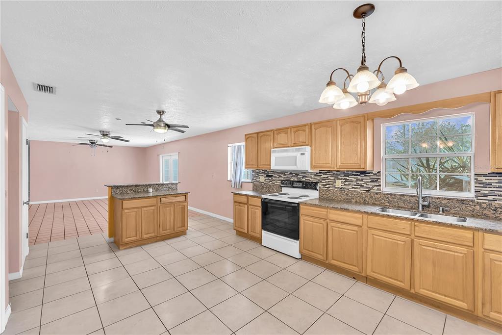 3420 Yale Circle Riverview, FL 33578 - Photo 8 of 30 a kitchen with stainless steel appliances granite countertop a stove and a sink