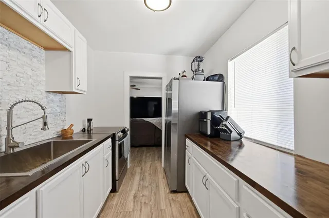 a kitchen with a sink appliances and cabinets
