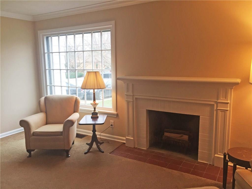 979 Mayfield Road Sharpsville, PA 16150 - Photo 4 of 25 The functional wood burning fireplace and a large window allowing light to stream in.