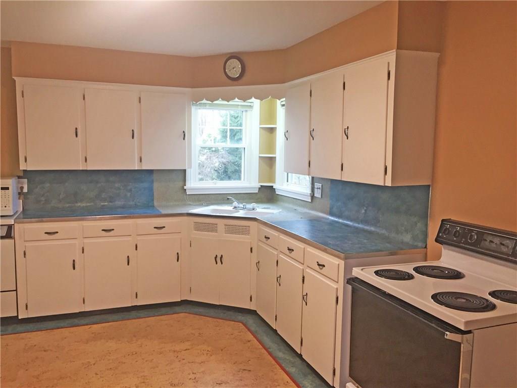 979 Mayfield Road Sharpsville, PA 16150 - Photo 7 of 25 Spacious kitchen welcomes more than one cook at a time ! Twelve cabinets, six drawers, and under the sink storage. The bright light coming from the two corner windows that look out to the back yard. Small corner shelves for cookbooks or house plants.