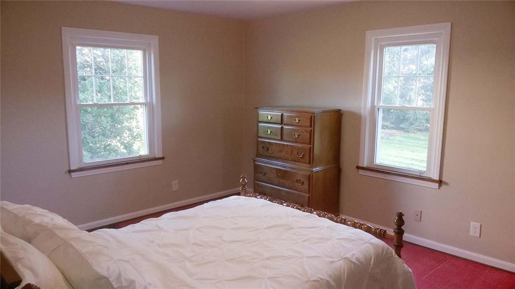 979 Mayfield Road Sharpsville, PA 16150 - Photo 10 of 25 Bedroom two has a large closet and a built in shelf/bookcase unit. Wood floors are under the carpeting.