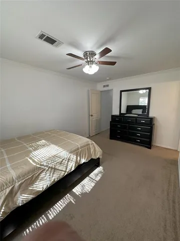 a bedroom with bed and a ceiling fan