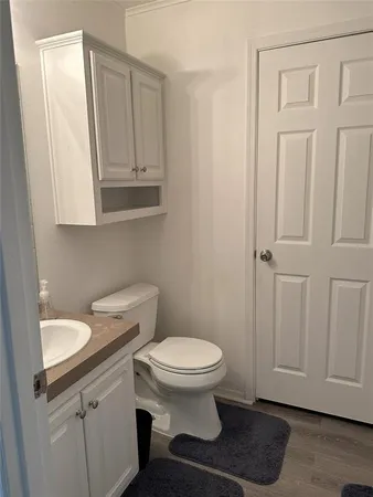 a bathroom with a sink a toilet and vanity