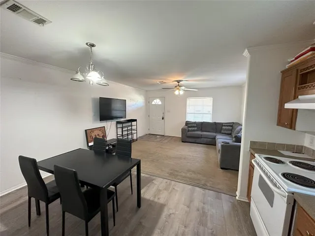 a kitchen with a dining table and chairs