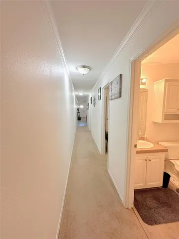 a view of a hallway with wooden floor and entryway