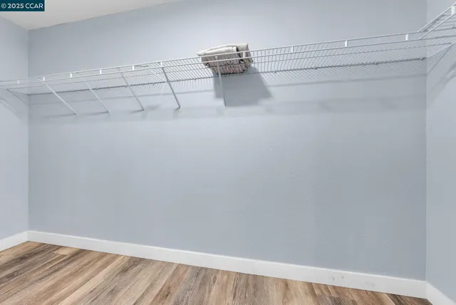 a room with a bench and a wooden floor