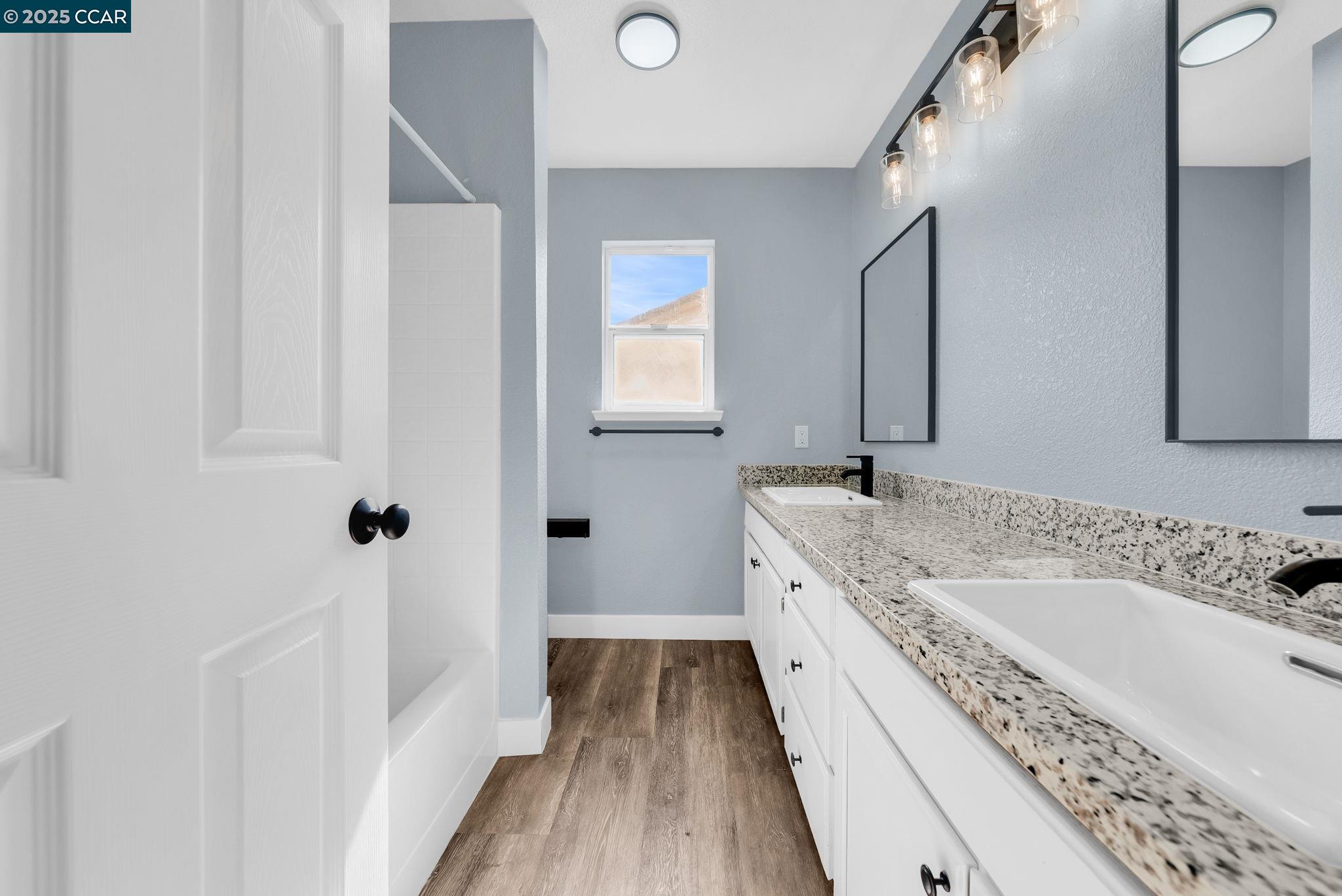 Discovery Bay Discovery Bay, CA 94505 - Photo 15 of 21 a bathroom with a granite countertop double vanity sink a mirror and a bathtub