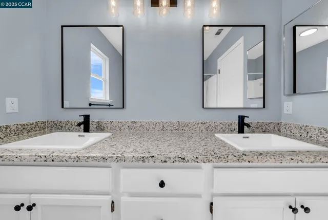 a bathroom with sink and mirror