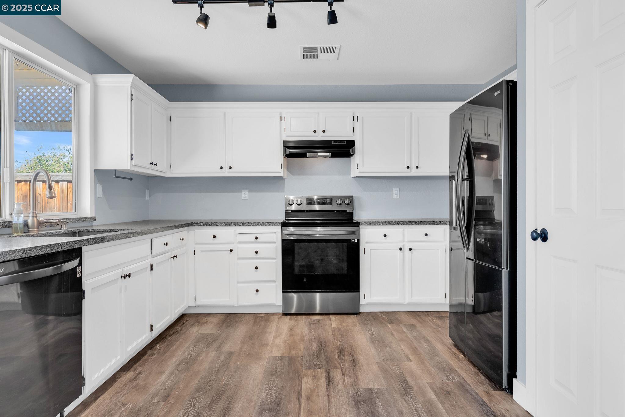 Discovery Bay Discovery Bay, CA 94505 - Photo 3 of 21 a kitchen with granite countertop a stove and a refrigerator
