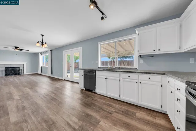 a view of a kitchen with granite countertop cabinets and wooden floor