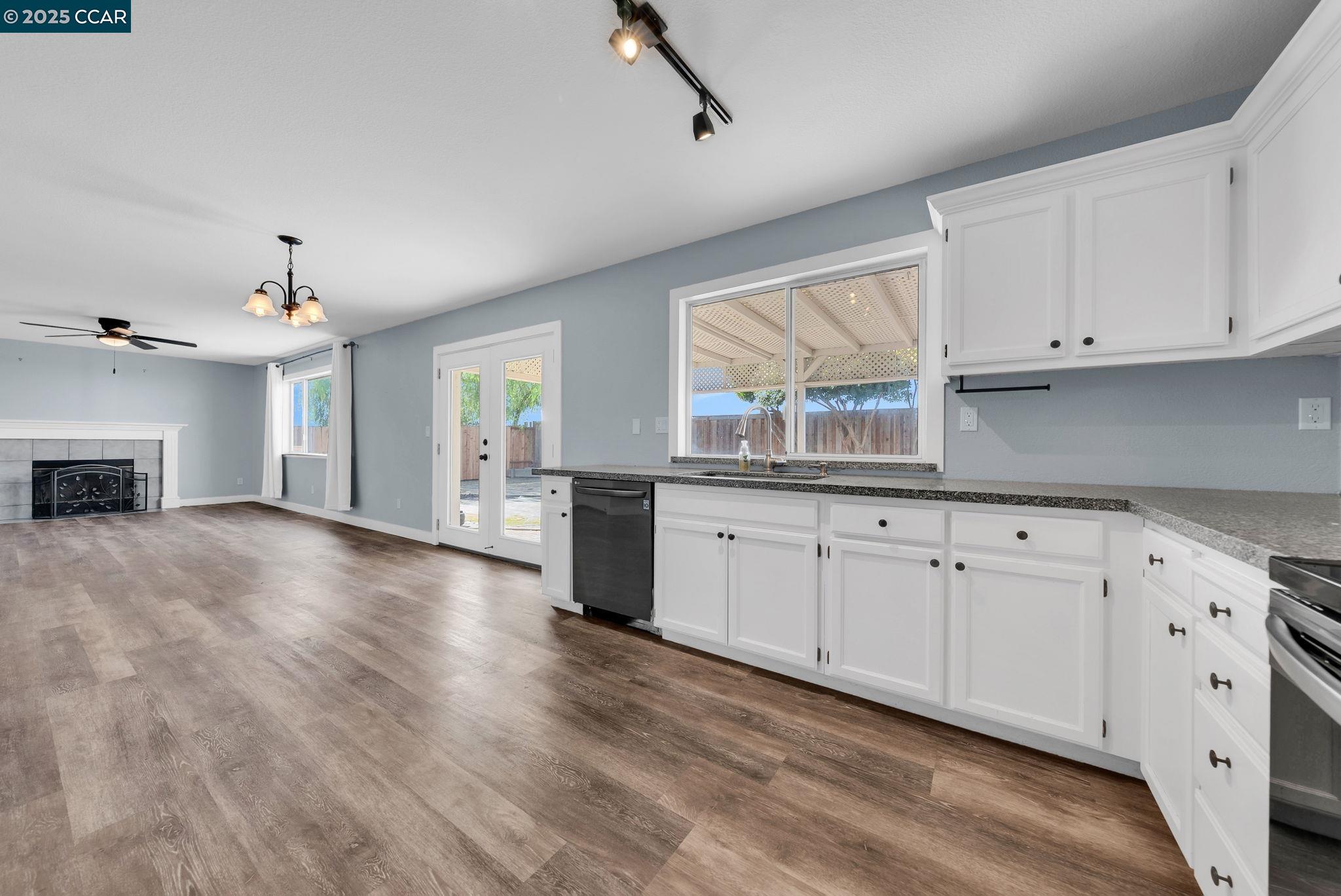 Discovery Bay Discovery Bay, CA 94505 - Photo 4 of 21 a view of a kitchen with granite countertop cabinets and wooden floor