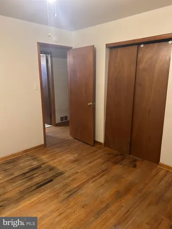 a bedroom with a bed and lamp on table