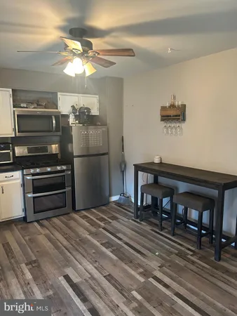 a kitchen with kitchen island a stove and a refrigerator