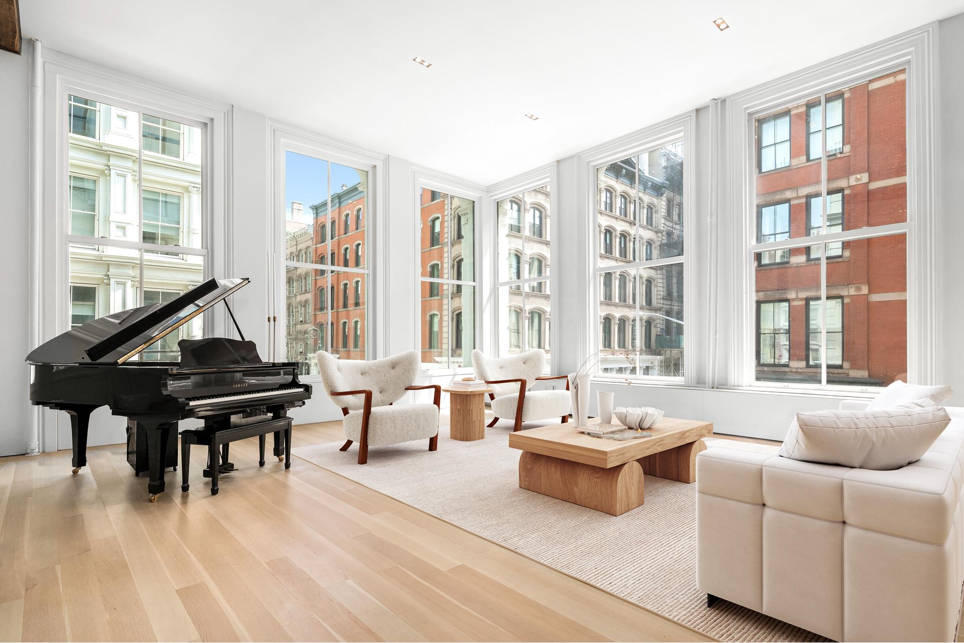 a living room with furniture and floor to ceiling windows
