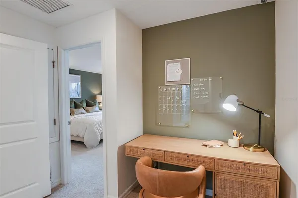 a bedroom with a bed and lamp