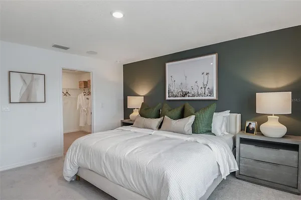 a bedroom with a bed and large window