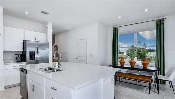 a living room with furniture and kitchen view