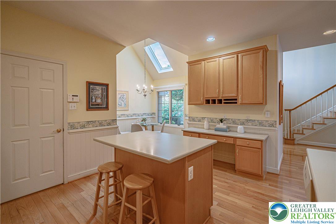 803 Dorset Road Allentown, PA 18104 - Photo 13 of 44 a kitchen with stainless steel appliances granite countertop a sink a stove a refrigerator a microwave oven with white cabinets and wooden floor