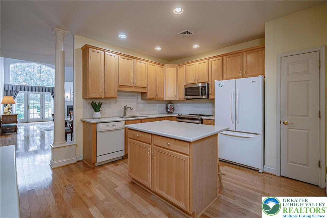 803 Dorset Road Allentown, PA 18104 - Photo 15 of 44 a kitchen with a refrigerator a stove top oven and wooden floors