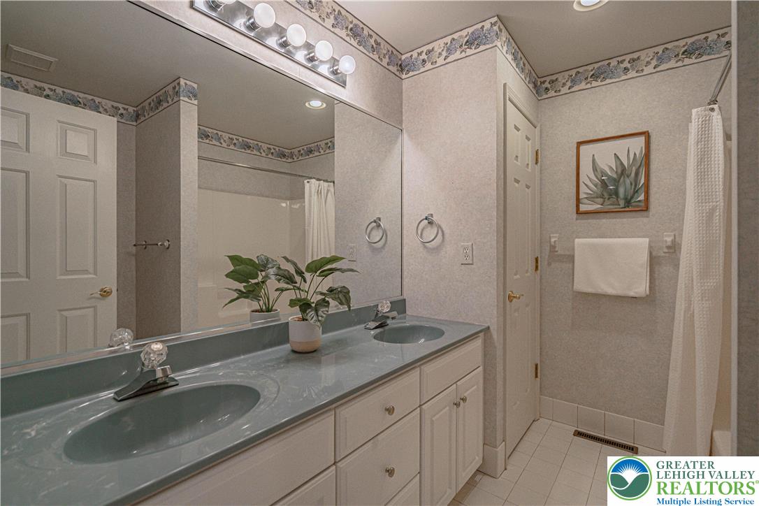 803 Dorset Road Allentown, PA 18104 - Photo 31 of 44 a bathroom with a sink a mirror and a shower