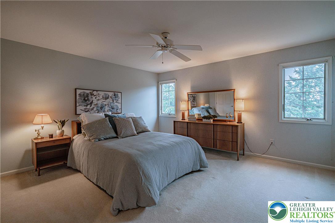 803 Dorset Road Allentown, PA 18104 - Photo 32 of 44 a bedroom with a bed and a chandelier