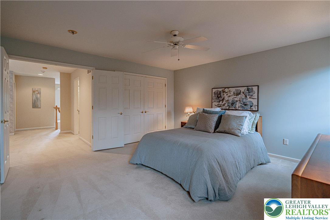 803 Dorset Road Allentown, PA 18104 - Photo 33 of 44 a spacious bedroom with a bed and a chandelier