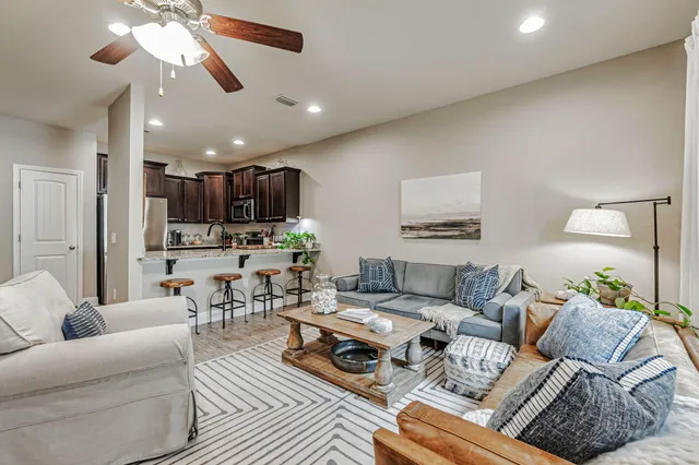 a living room with furniture and kitchen view