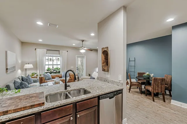 a kitchen with sink and view of living room