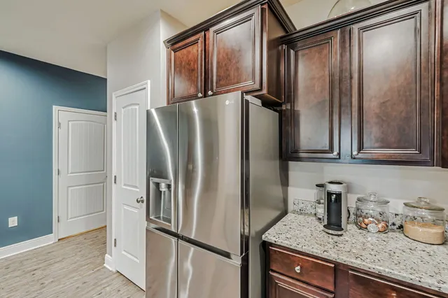a kitchen with granite countertop stainless steel appliances a refrigerator and counter space