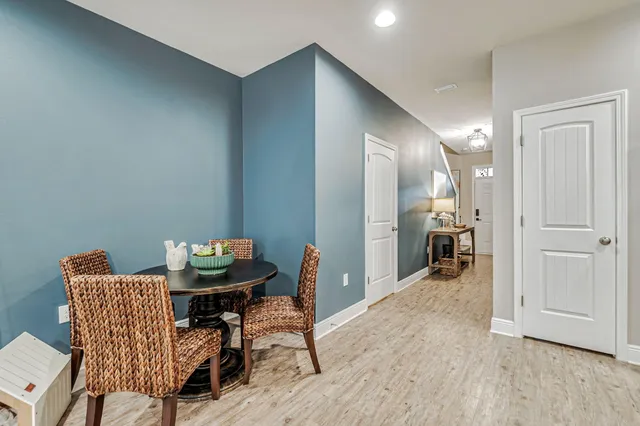 a view of a livingroom with furniture and a hallway