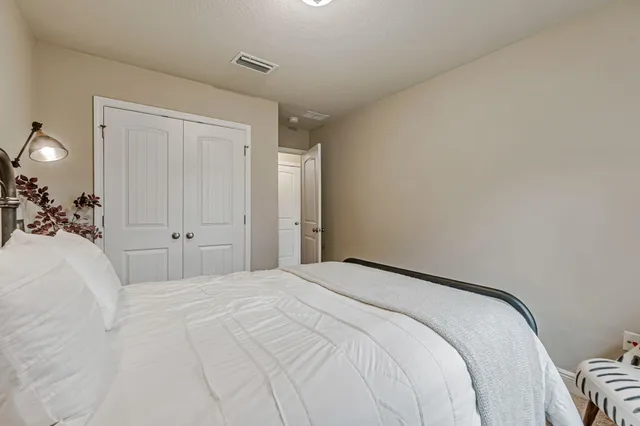 a bedroom with a bed and a cabinets