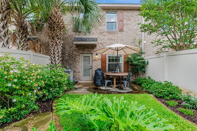 a view of a patio with table and chairs and potted plants