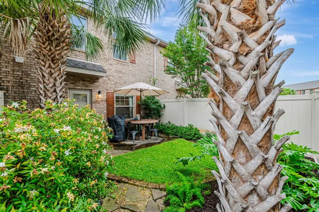 a view of a house with backyard sitting area and garden