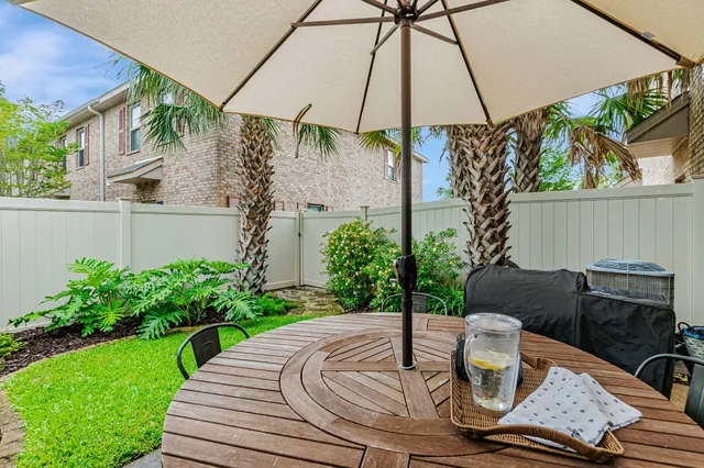 a view of an outdoor sitting area with chairs and an umbrella