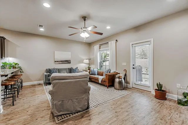 a living room with furniture and wooden floor