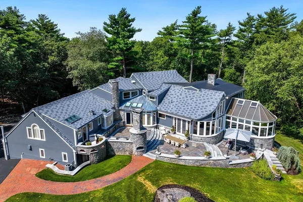 an aerial view of a house with swimming pool and garden
