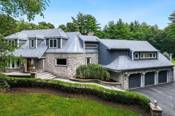 a house with a big yard and large trees